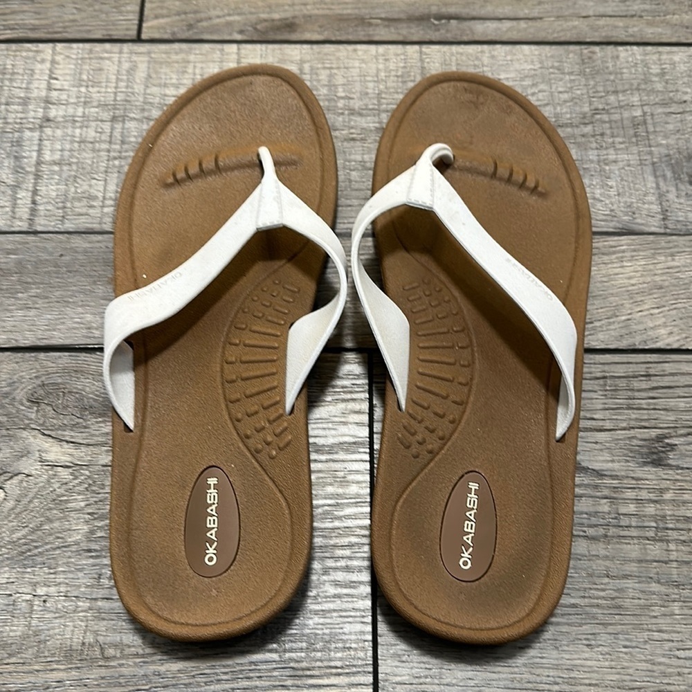 Okabashi flip flops with white straps and neutral color bottoms